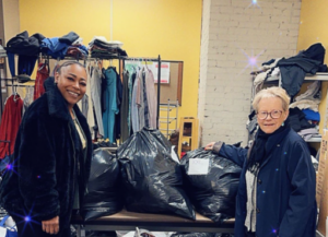 Board Member Amy H. donating clothes to Biddle House